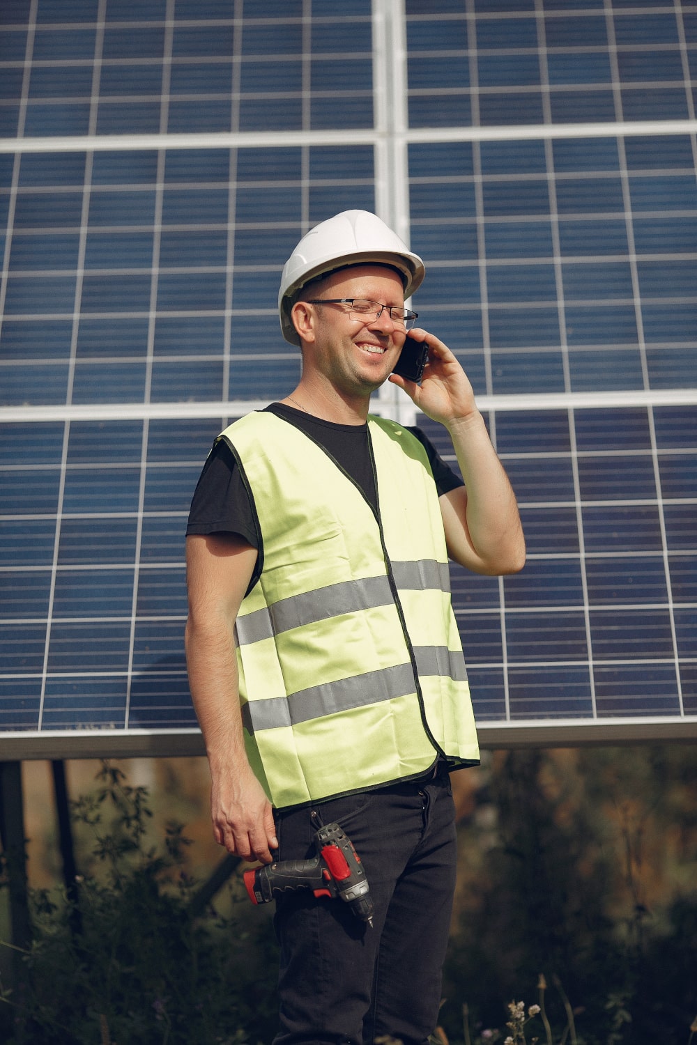 man-with-white-helmet-near-solar-panel-min